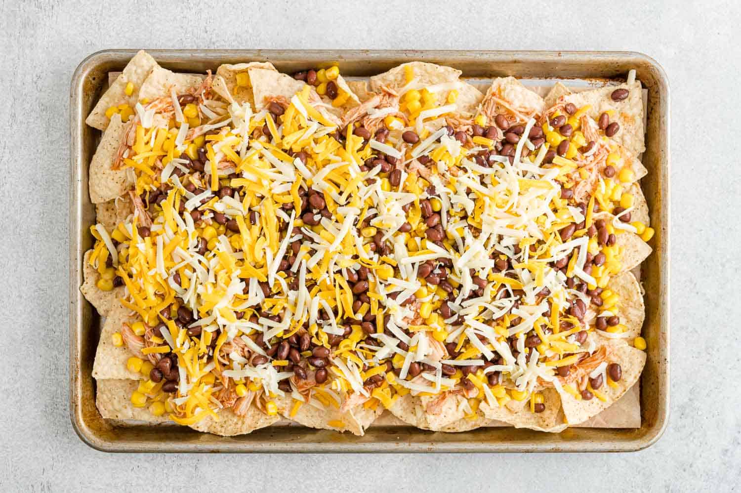 Cheese added to nachos.