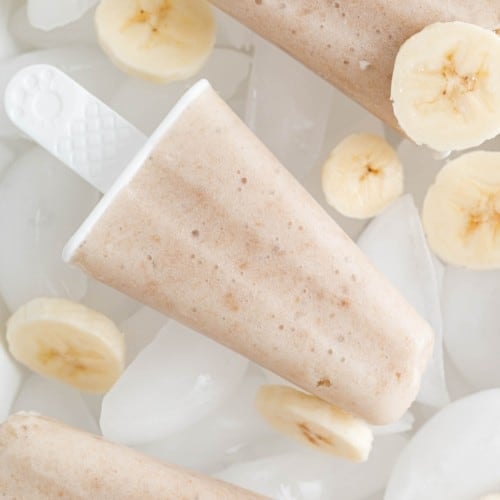 Banana popsicle surrounded by banana slices.