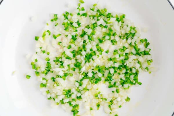 Peppers and onions in a frying pan.