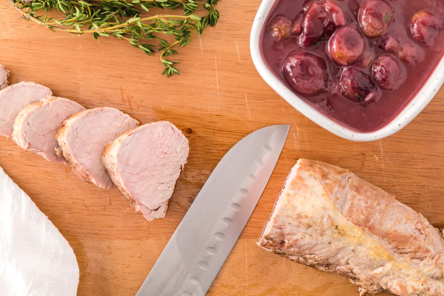 Pork tenderloin being sliced.