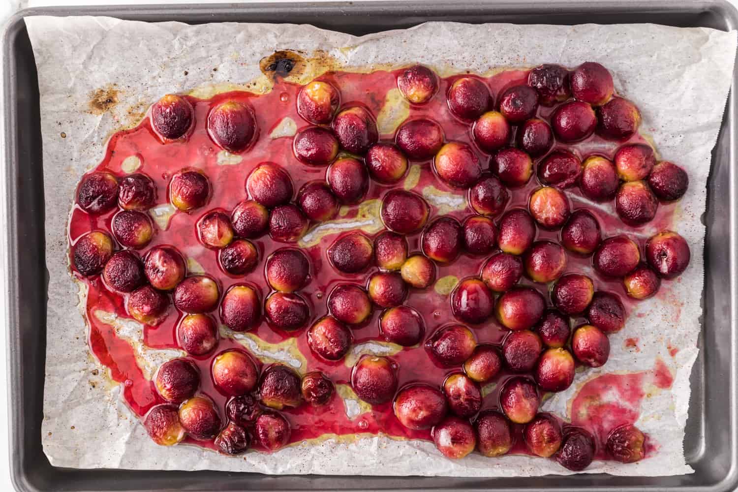 Roasted grapes on sheet pan.