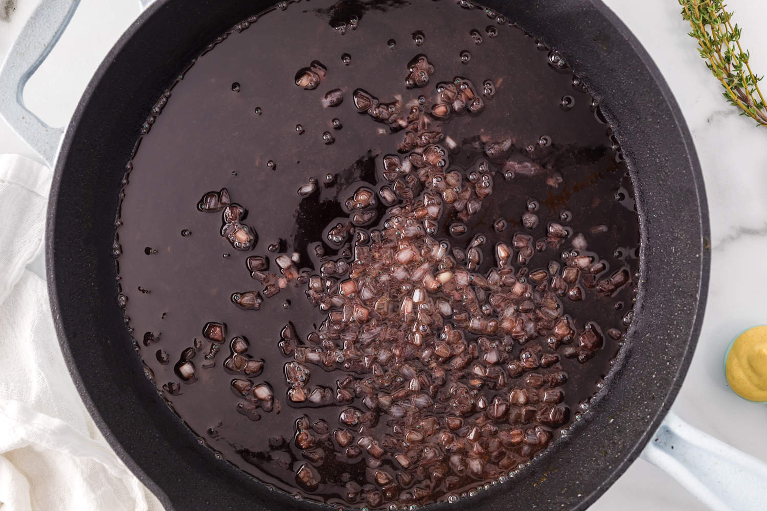 Diced shallots in pan.