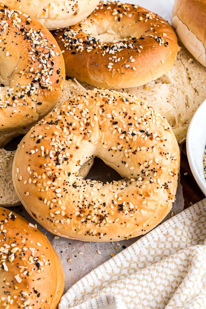 Close up of everything bagels next to a white cloth.