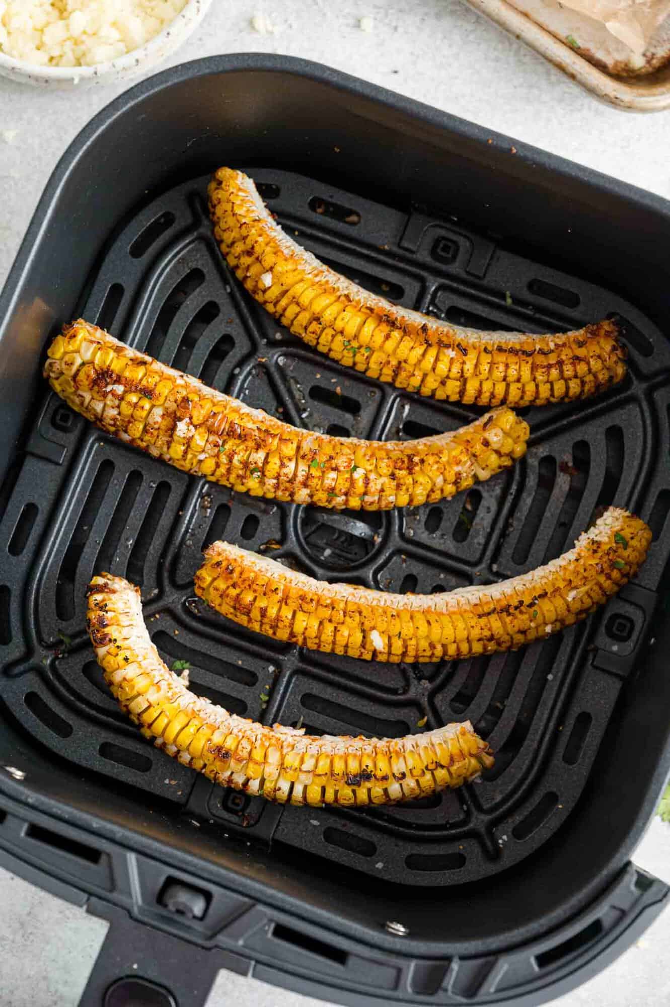 Corn ribs in an air fryer basket.