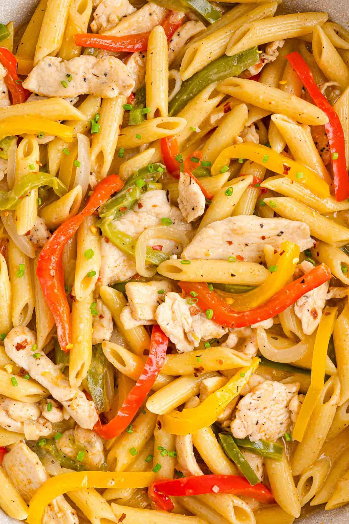 Close up of Rasta Pasta with chicken, bell peppers, and onions.