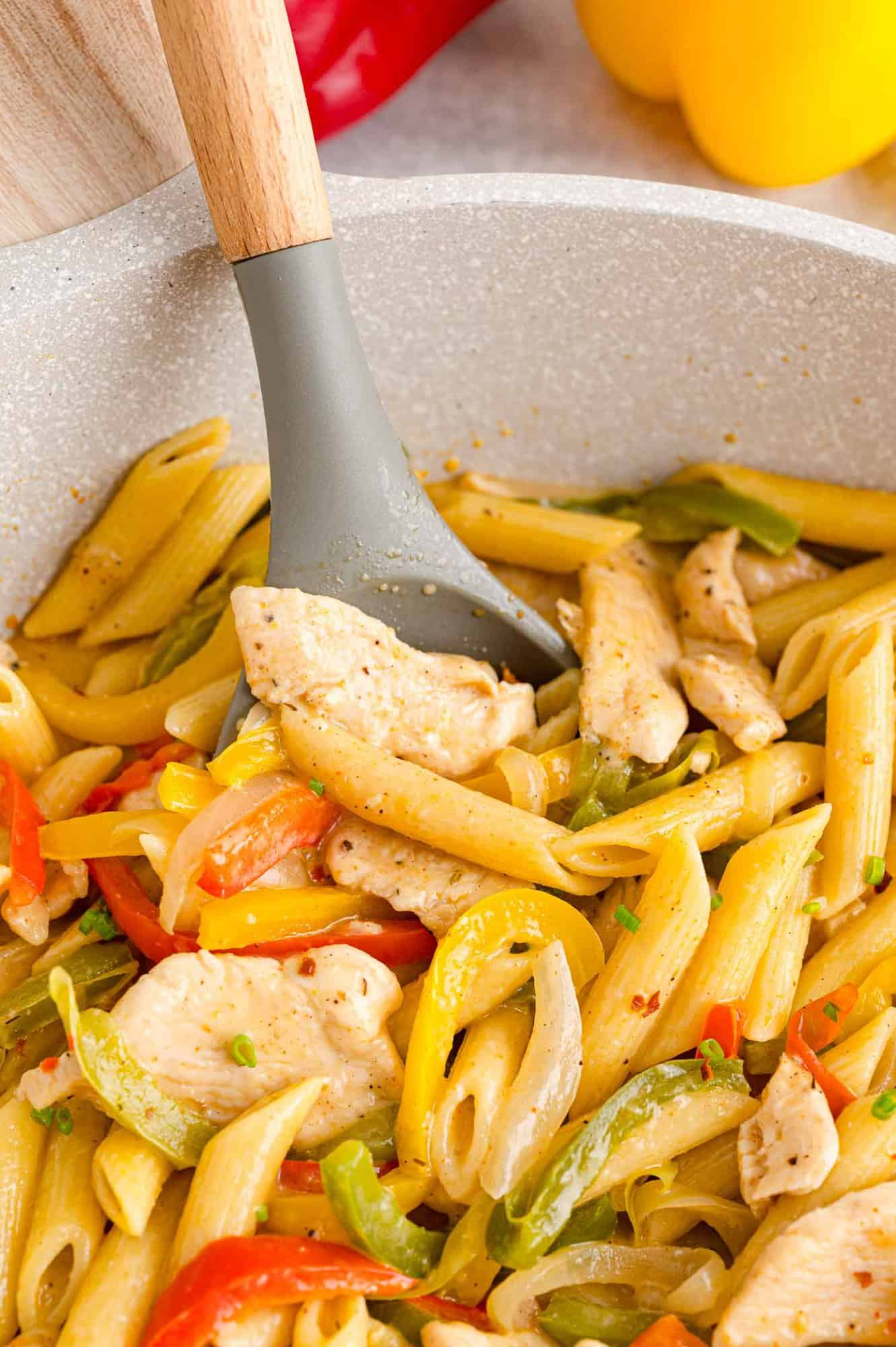 Close up of Rasta Pasta in a pot with a serving spoon.