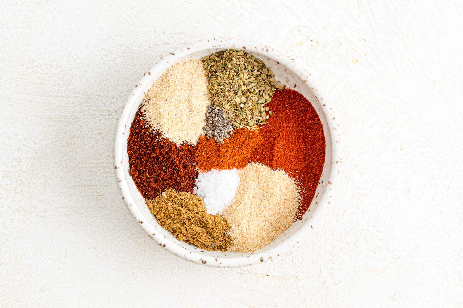 Southwest spice ingredients combined in a white bowl.