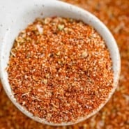 Close up of a spoonful of Southwest spice blend held over a bowl of seasoning.