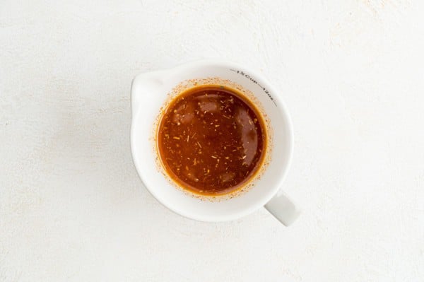 Overhead view of Southwestern marinade in a white spouted mixing bowl.