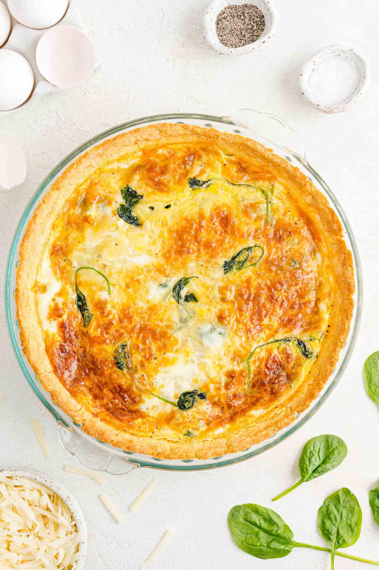 Overhead view of cooked spinach quiche.