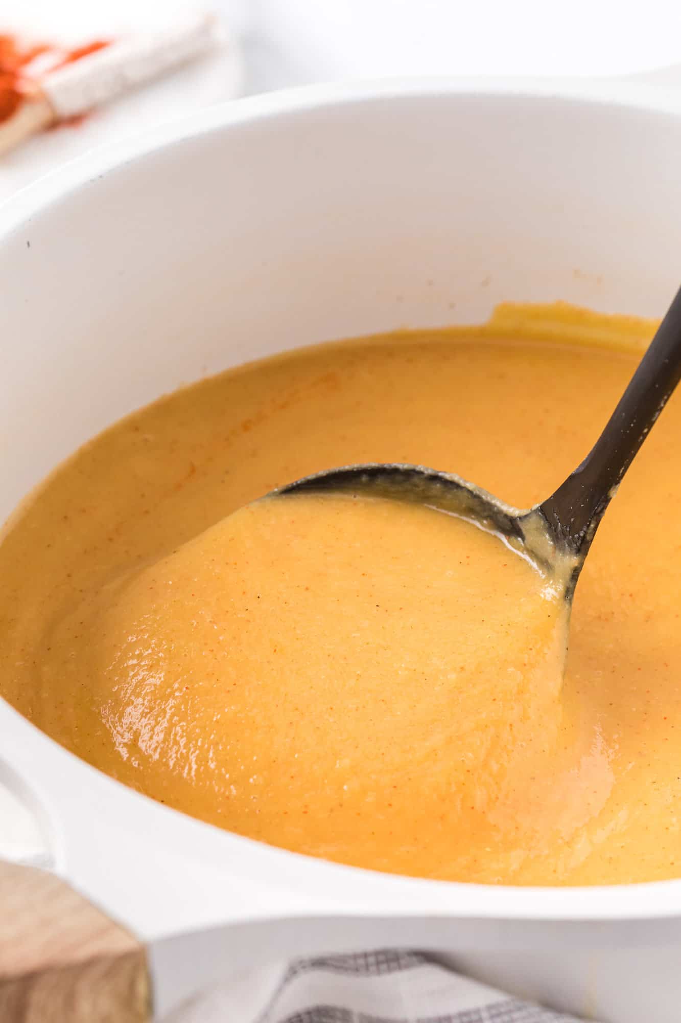 Squash soup on a ladle.