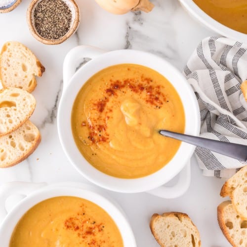 Vegan butternut squash soup in a white crock style bowl.