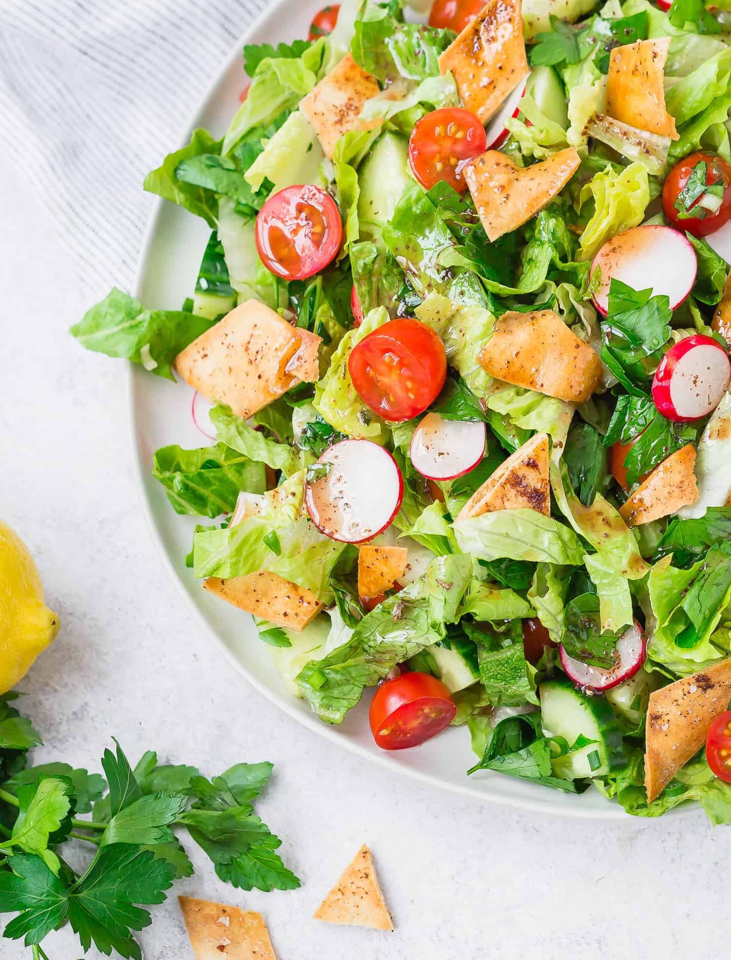 Salad with fresh greens, tomatoes, crispy pita, radishes.