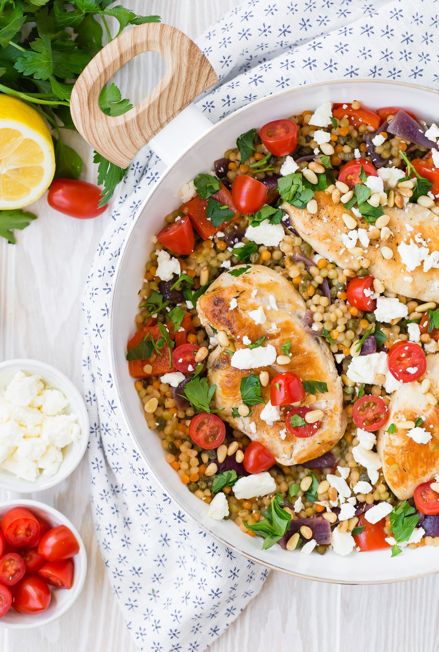 One pan chicken and couscous in a white skillet.