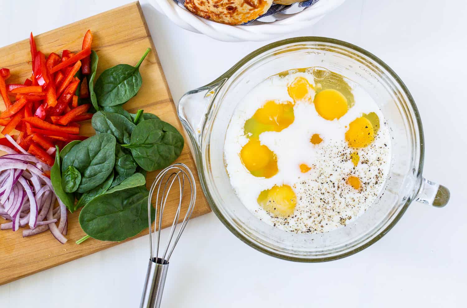 Eggs and milk in mixing bowl before whisking together.