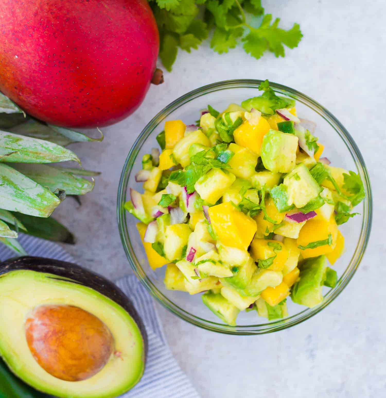 Mango avocado salsa in a small glass bowl.