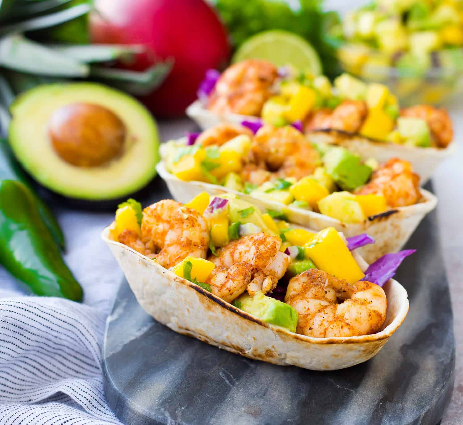 Shrimp tacos topped with mango avocado salsa.