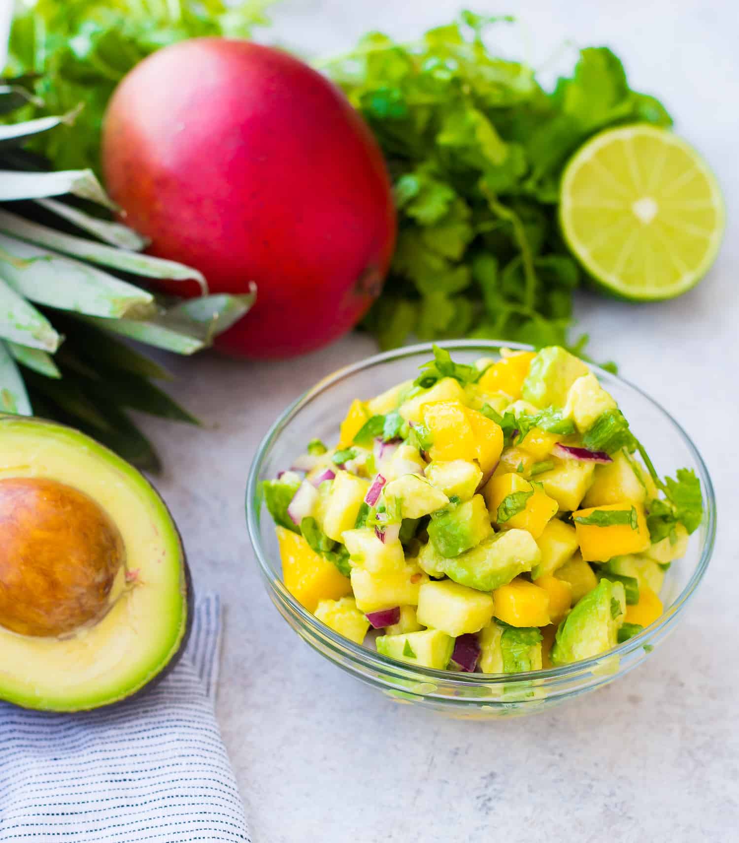 Mango avocado salsa, with a mango and an avocado nearby.