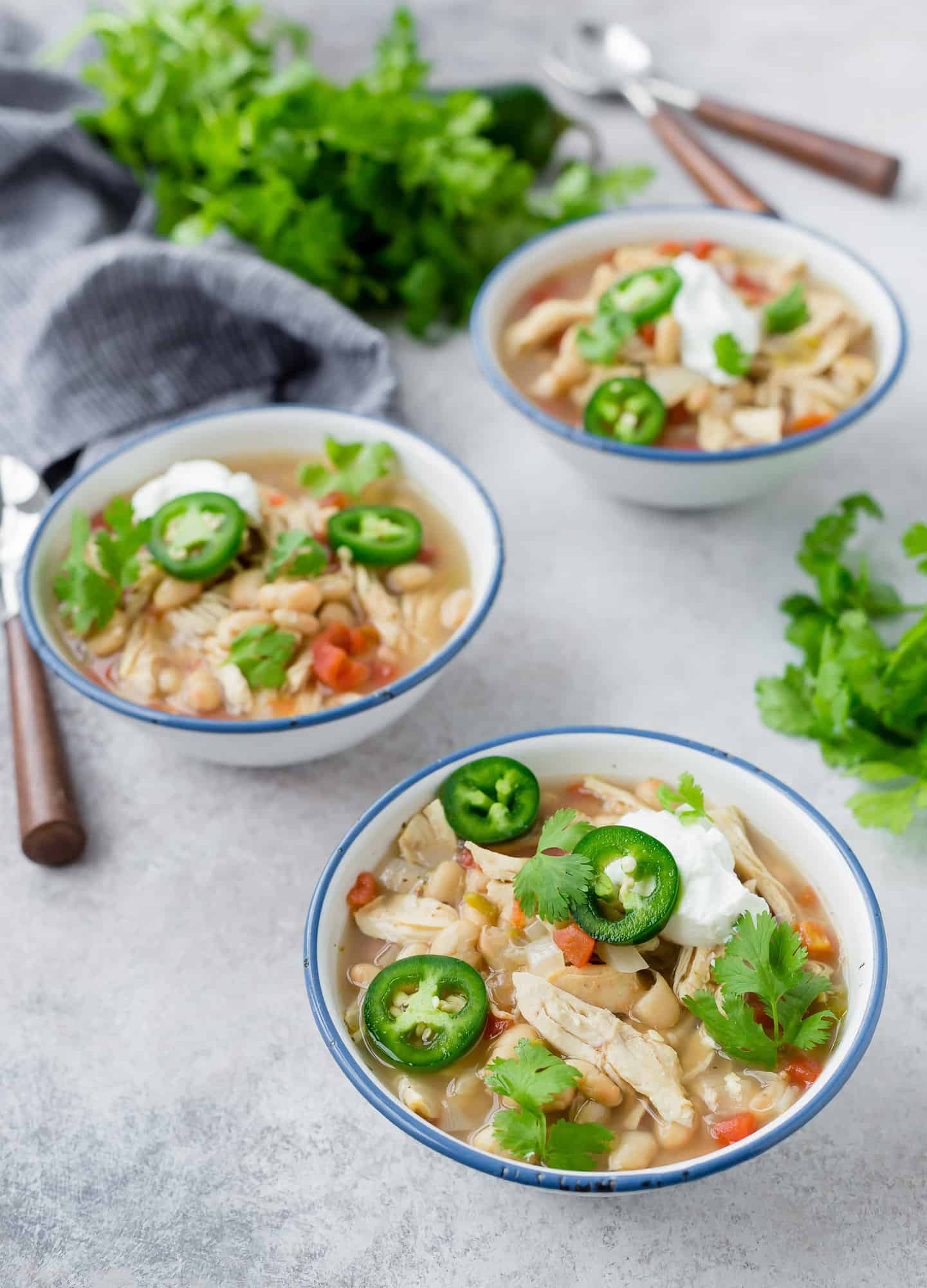 Three bowls of white chicken chili.