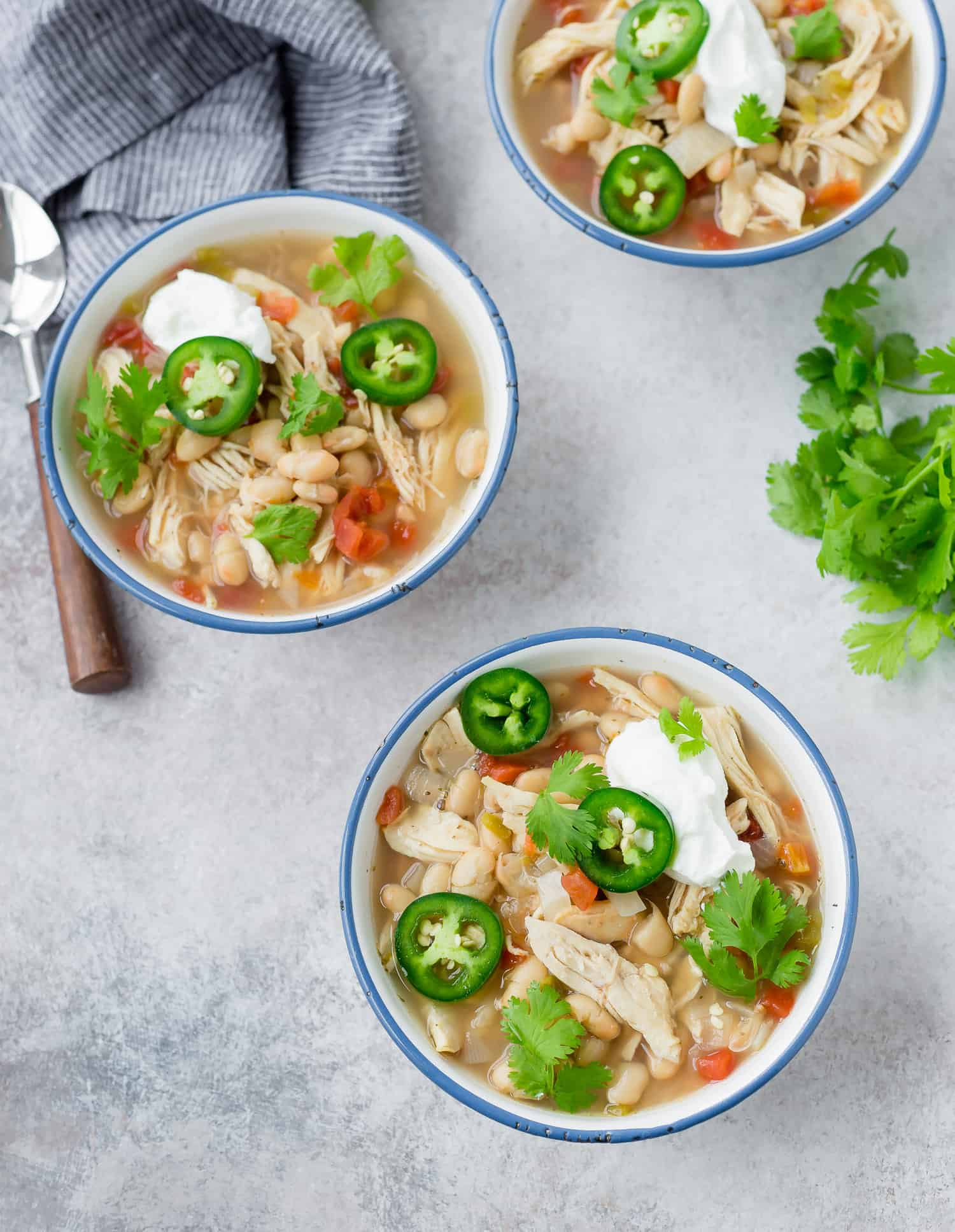 Three bowls of white chicken chili.