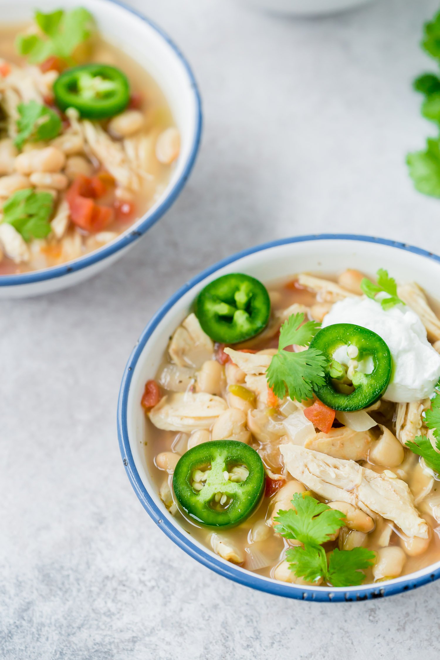 Slow Cooker White Chicken Chili in a Bowl with blue rim.