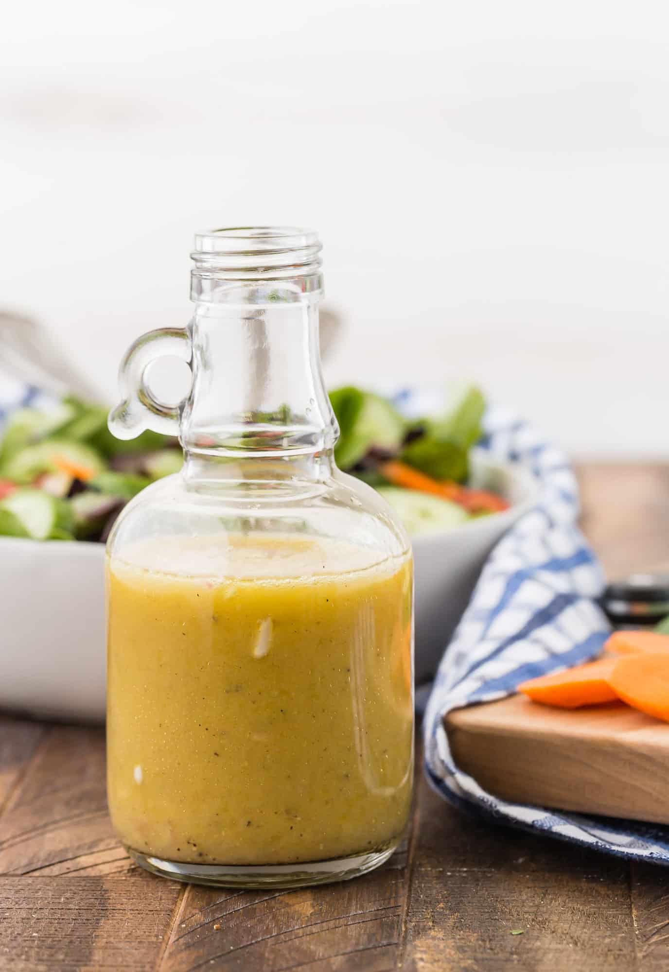 White wine vinaigrette with a salad in the background.