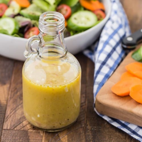 White wine vinaigrette in a small glass container.