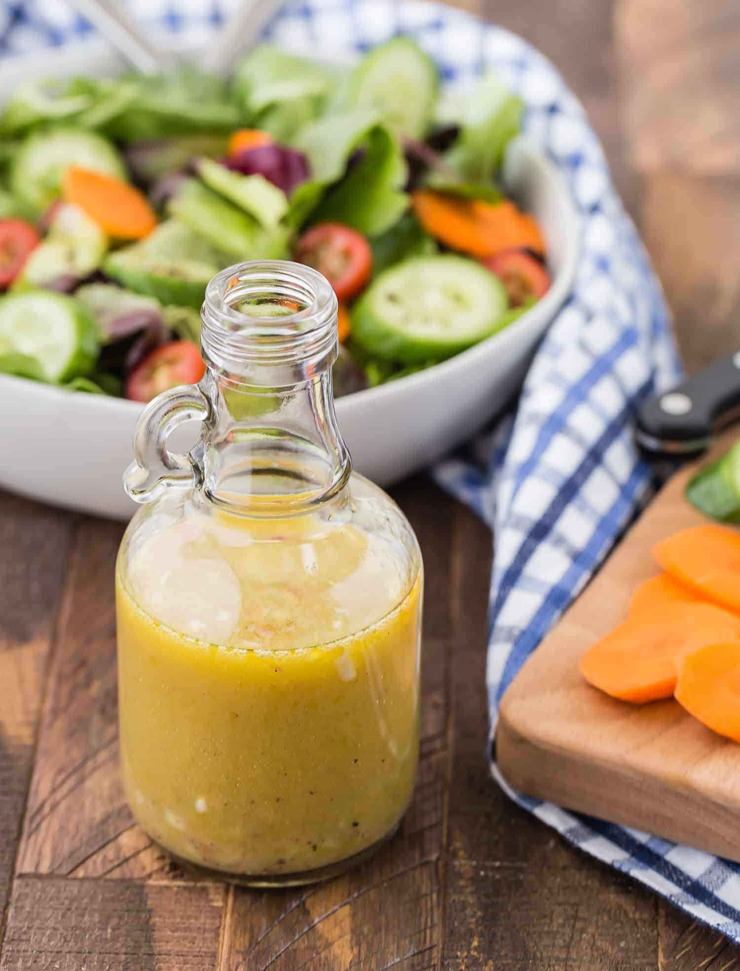 White wine vinaigrette with a salad in the background.