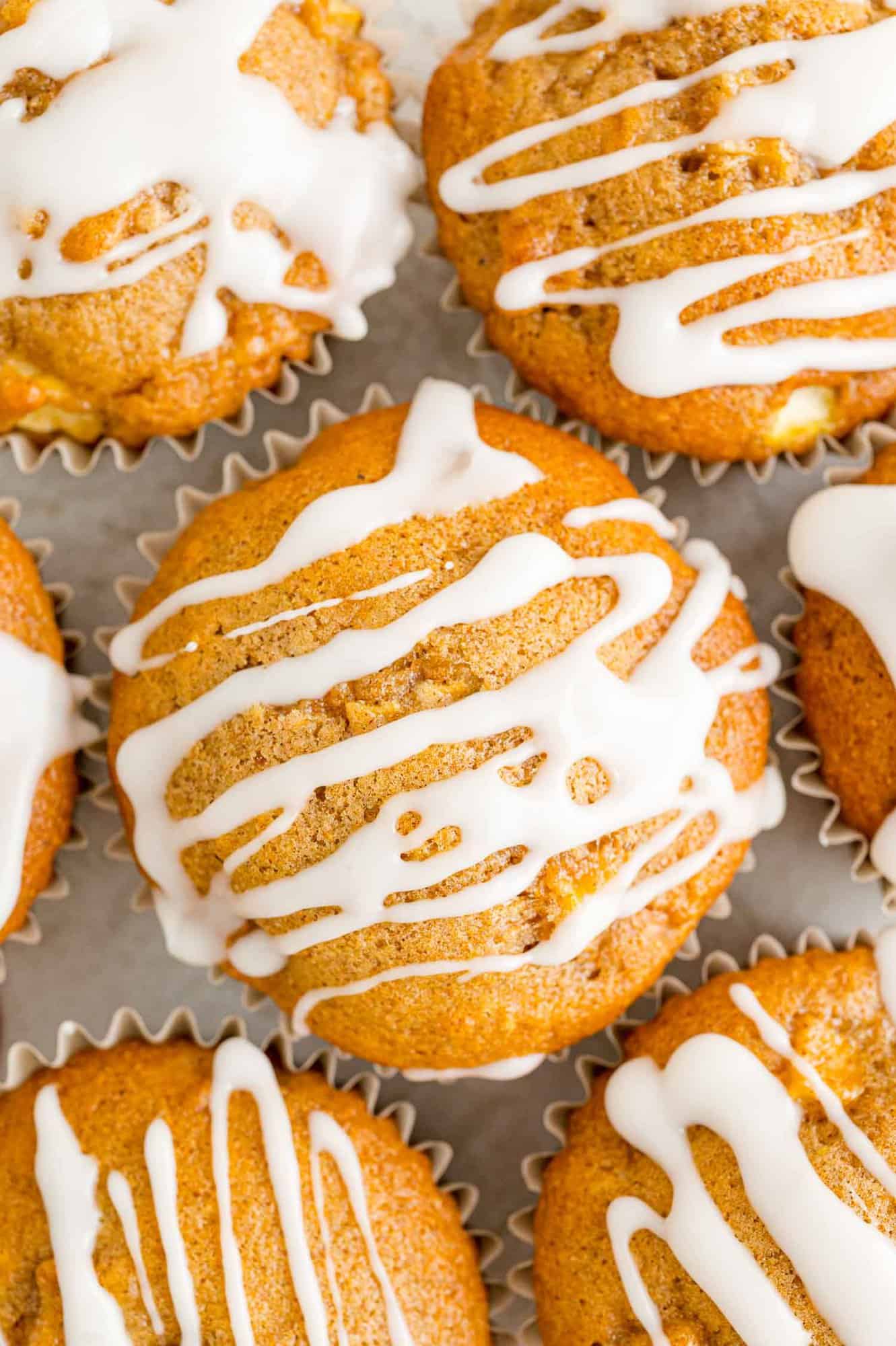 Overhead view of apple cider muffins with icing.