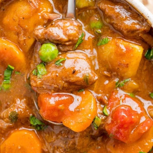 Instant Pot beef stew shown on a spoon.