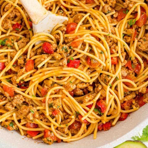One pot Mexican spaghetti in a pan with a serving spoon.