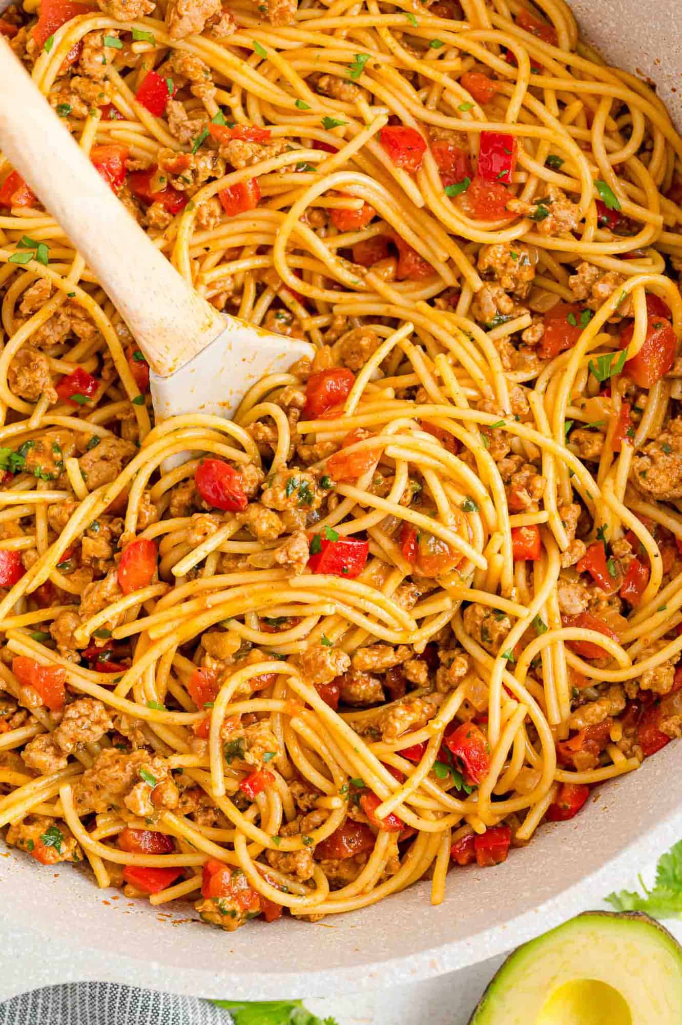 One pot Mexican spaghetti in a pan with a serving spoon.