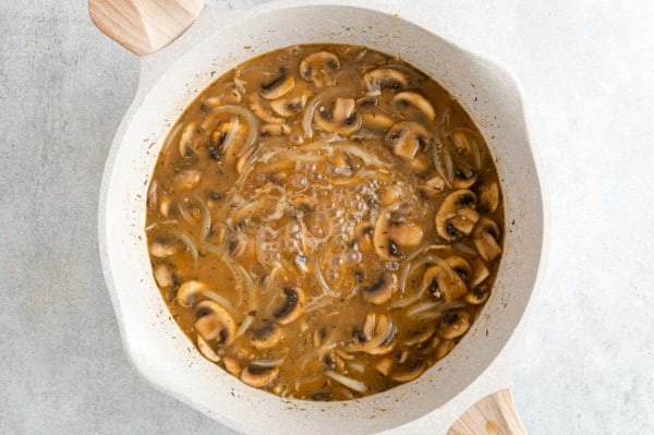 Mushroom and onion gravy in a skillet.