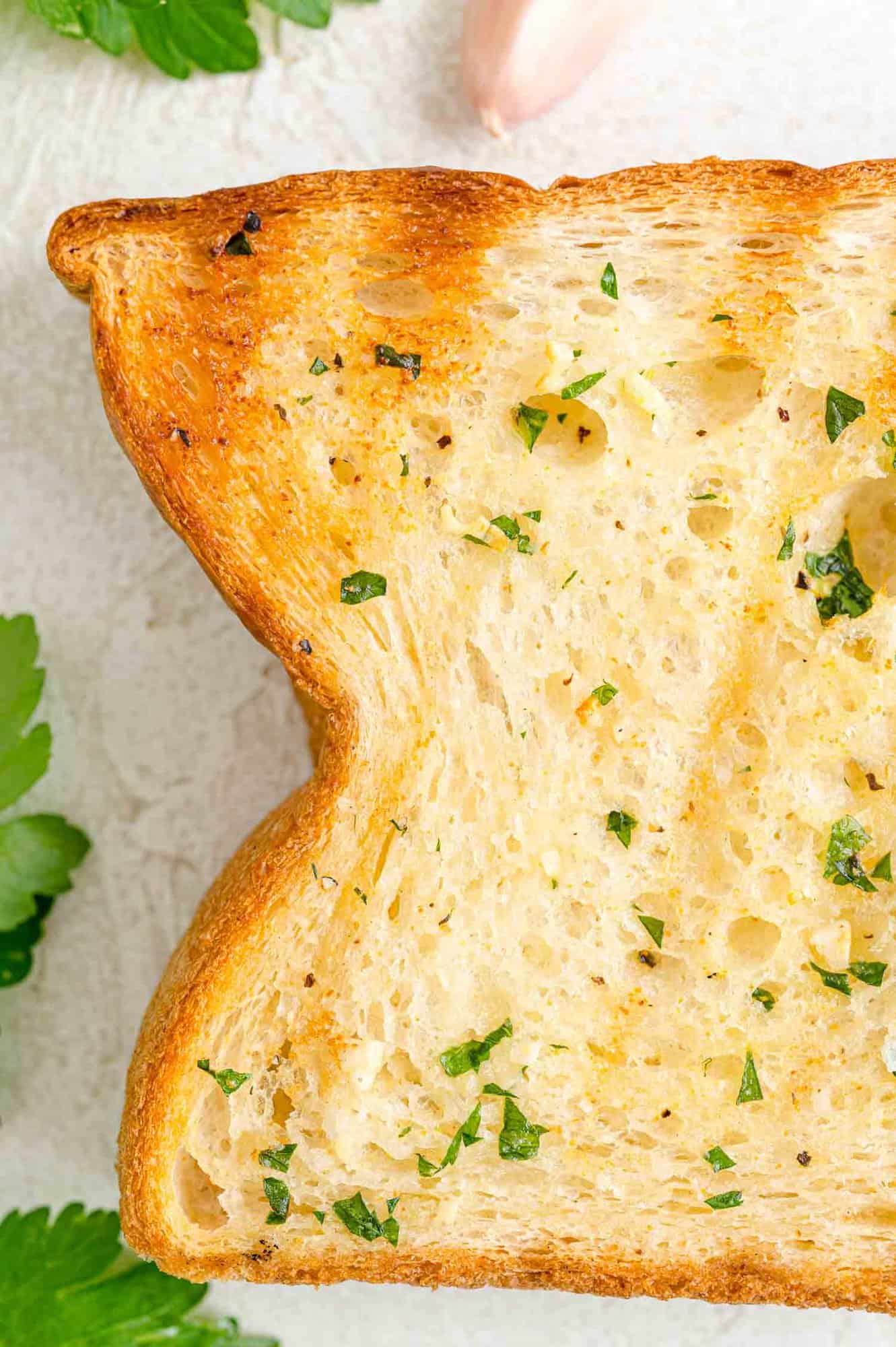 Close up of a toasted slice of Texas toast garlic bread.