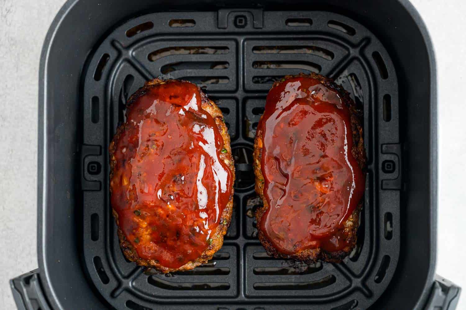 Air fryer meatloaf with glaze, still in air fryer.