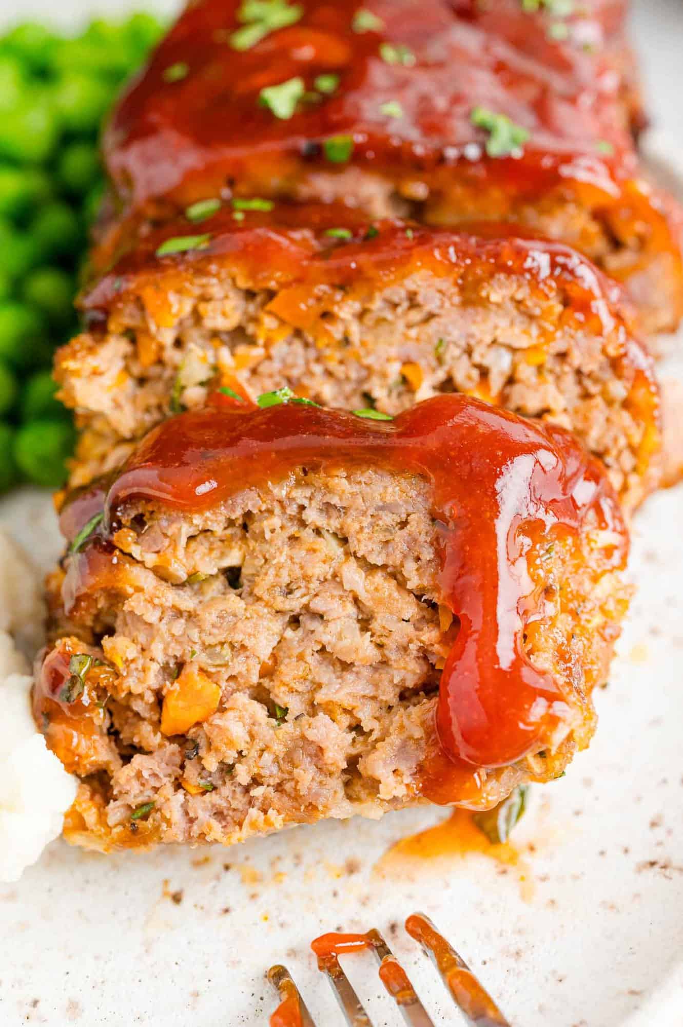 Glaze dripping down a slice of air fryer meatloaf.