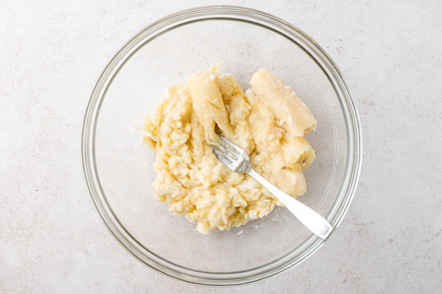 Banana being mashed for muffins.