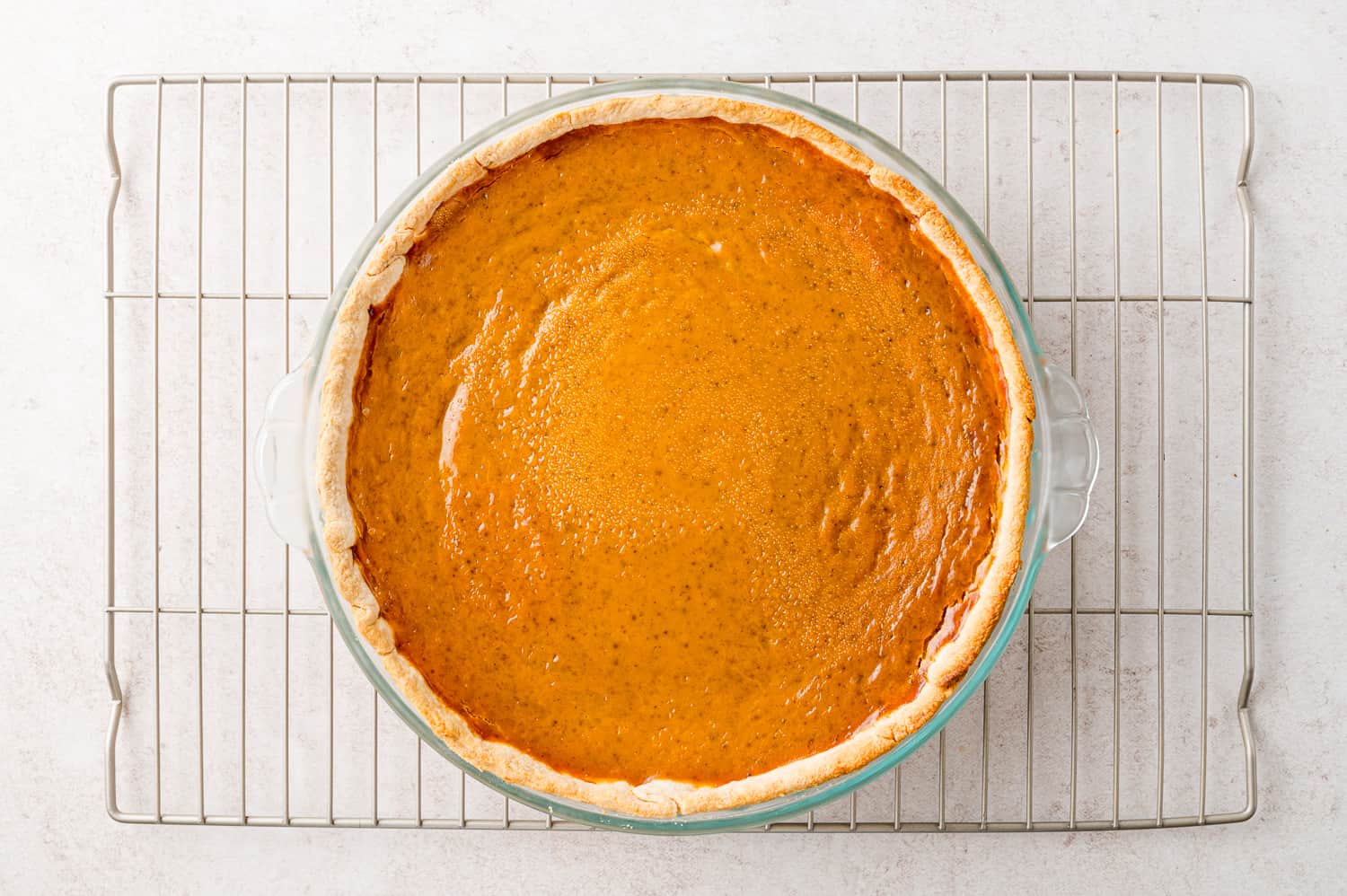 Bake pumpkin pie on a cooling rack.