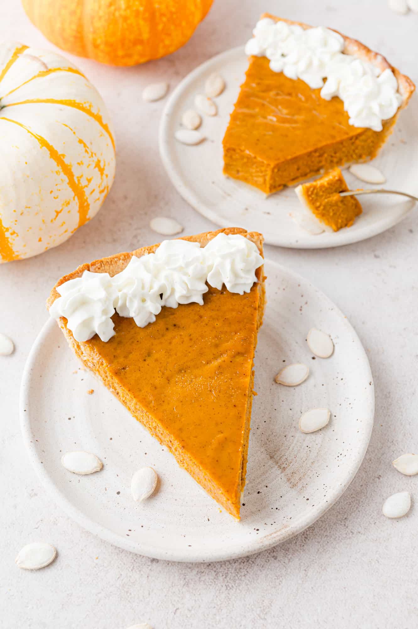 Pumpkin pie on a white plate.