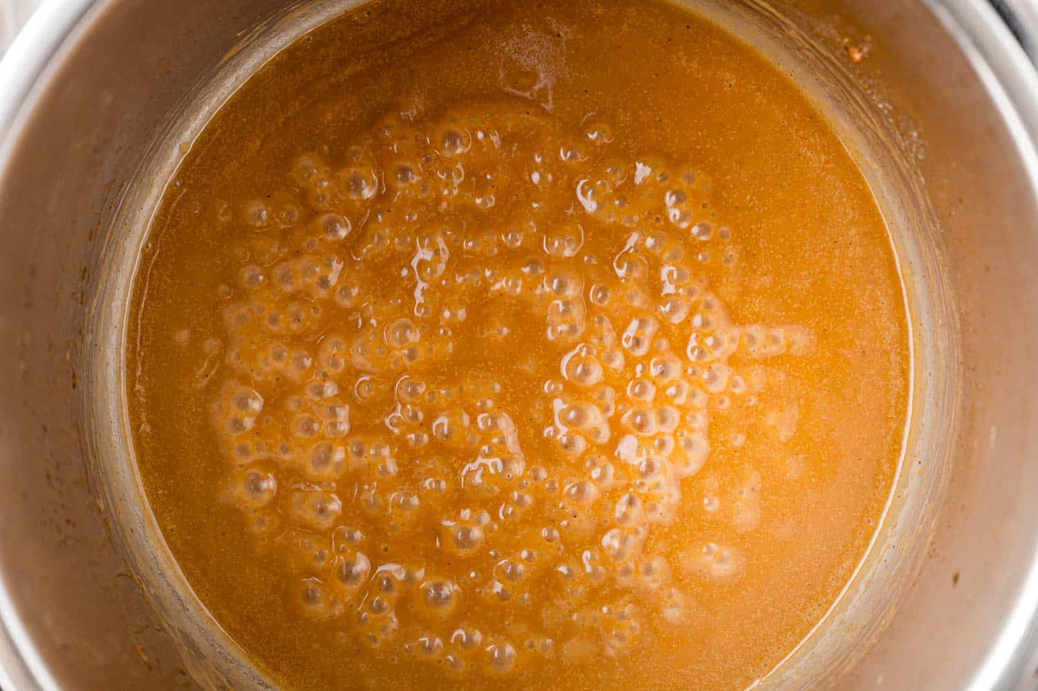 Chicken gravy in the Instant Pot, light brown in color.