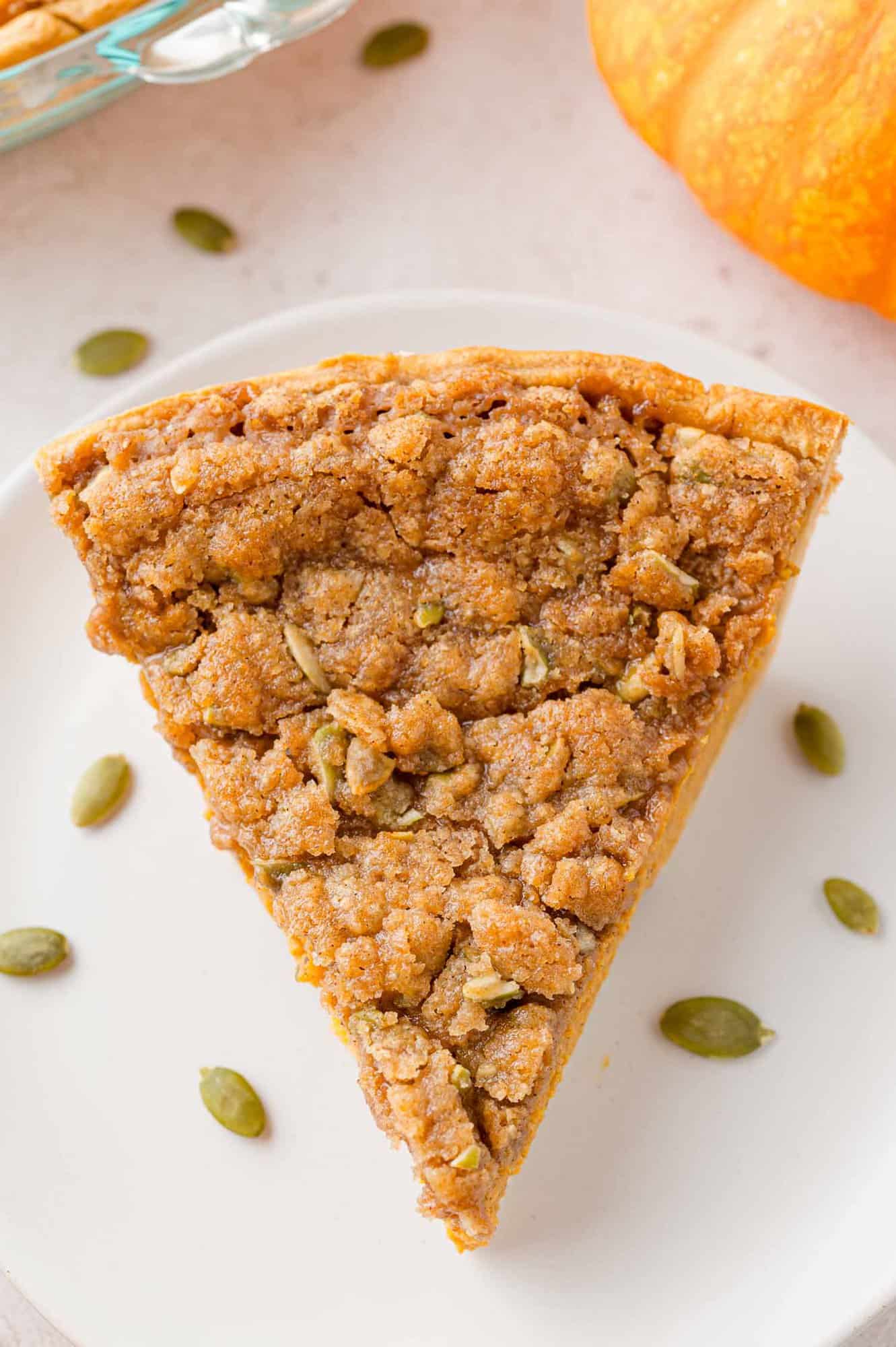 Overhead view of a slice of streusel topped pumpkin pie.