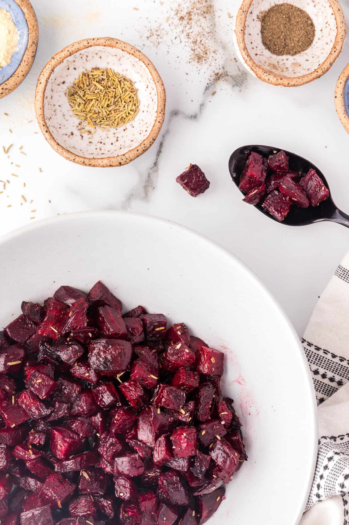 Roasted beets in a white bowl.