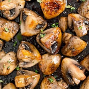 Sautéed mushrooms with marsala, filling the frame, sprinkled with herbs.
