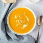Pumpkin soup, swirled with cream.