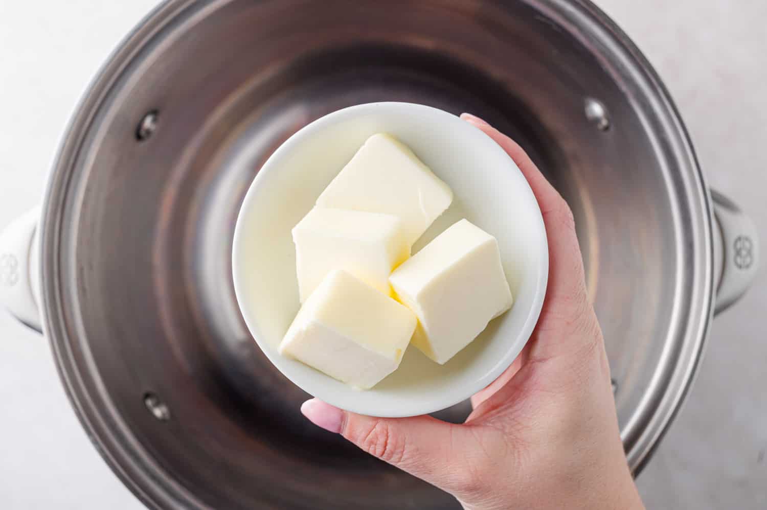 Butter being added to pan.