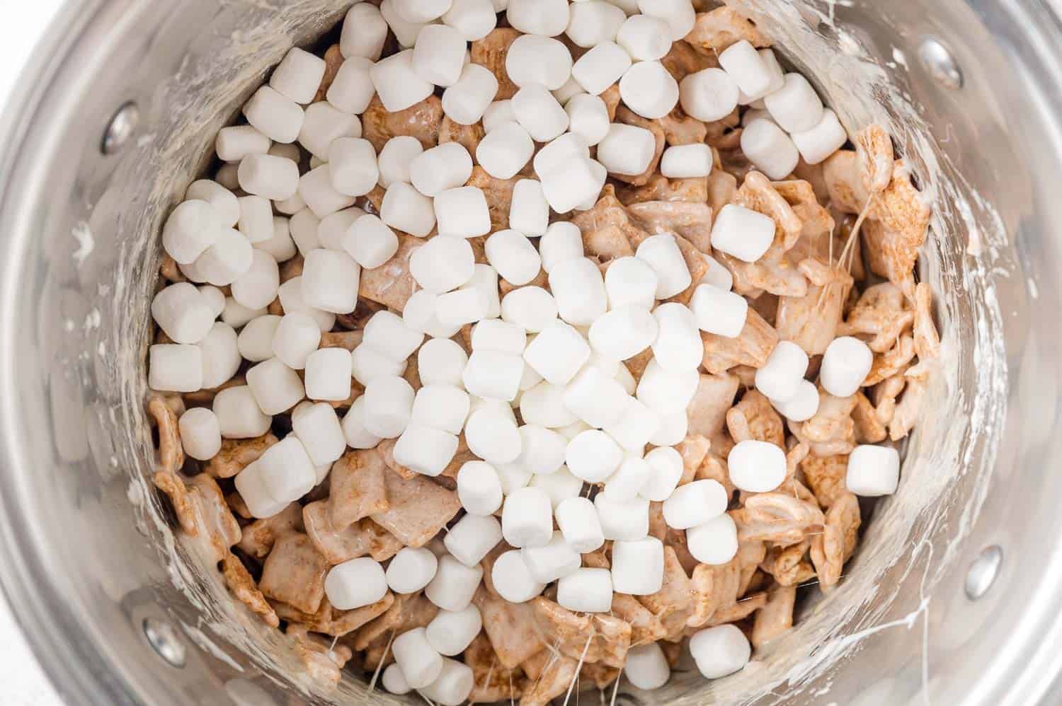 Mini marshmallows added to marshmallow and cereal mixture.