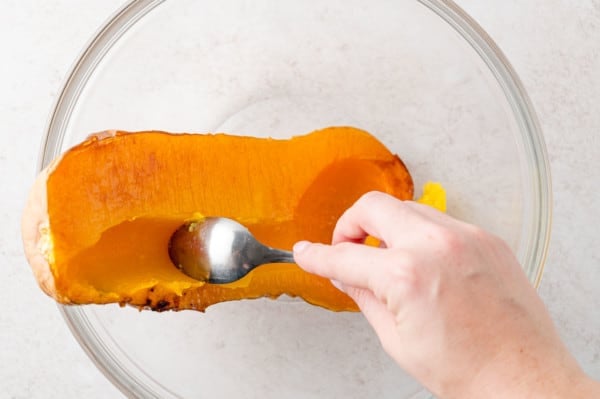 Squash being scooped out of the peel.