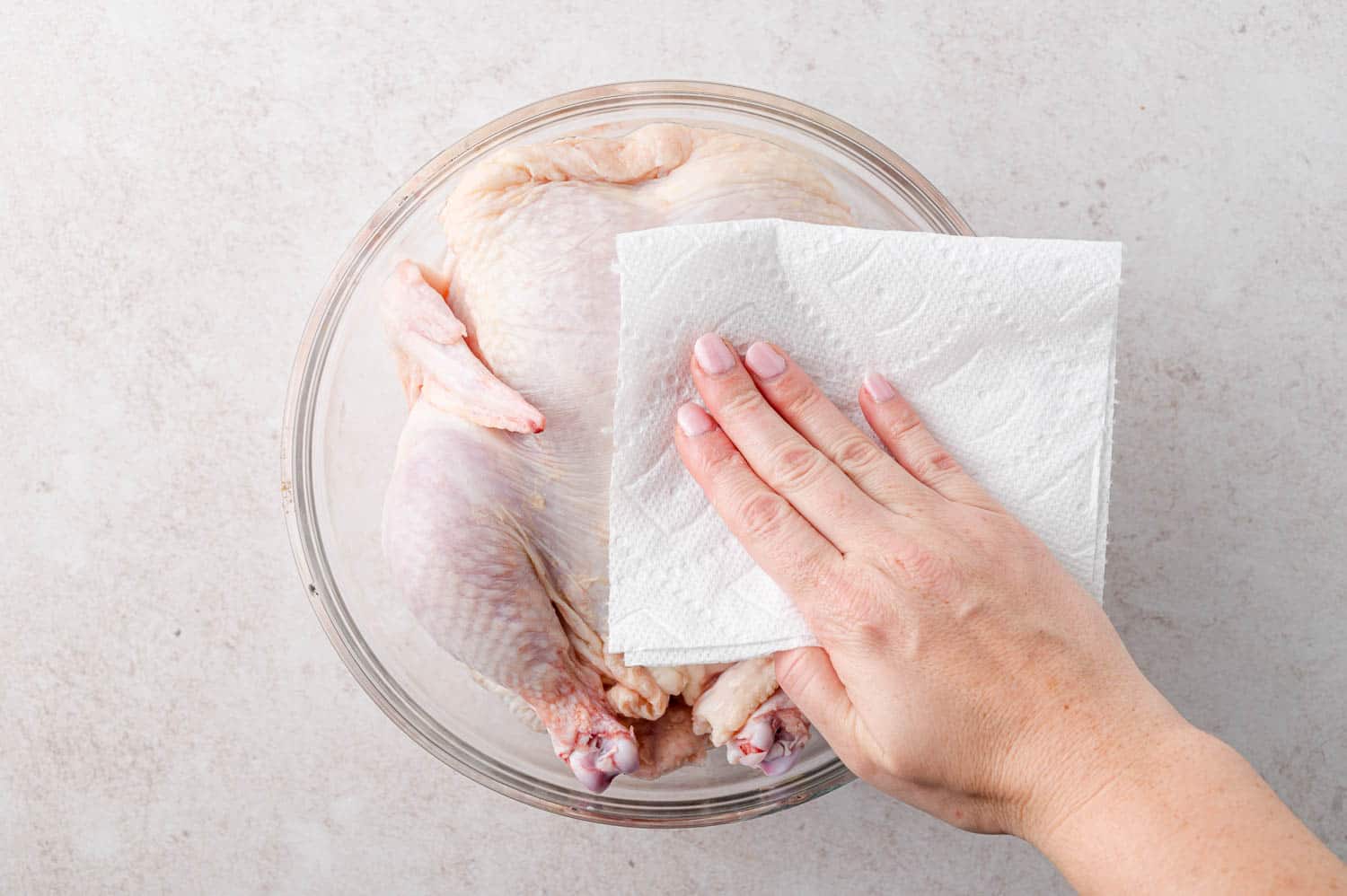 Chicken being patted dry.