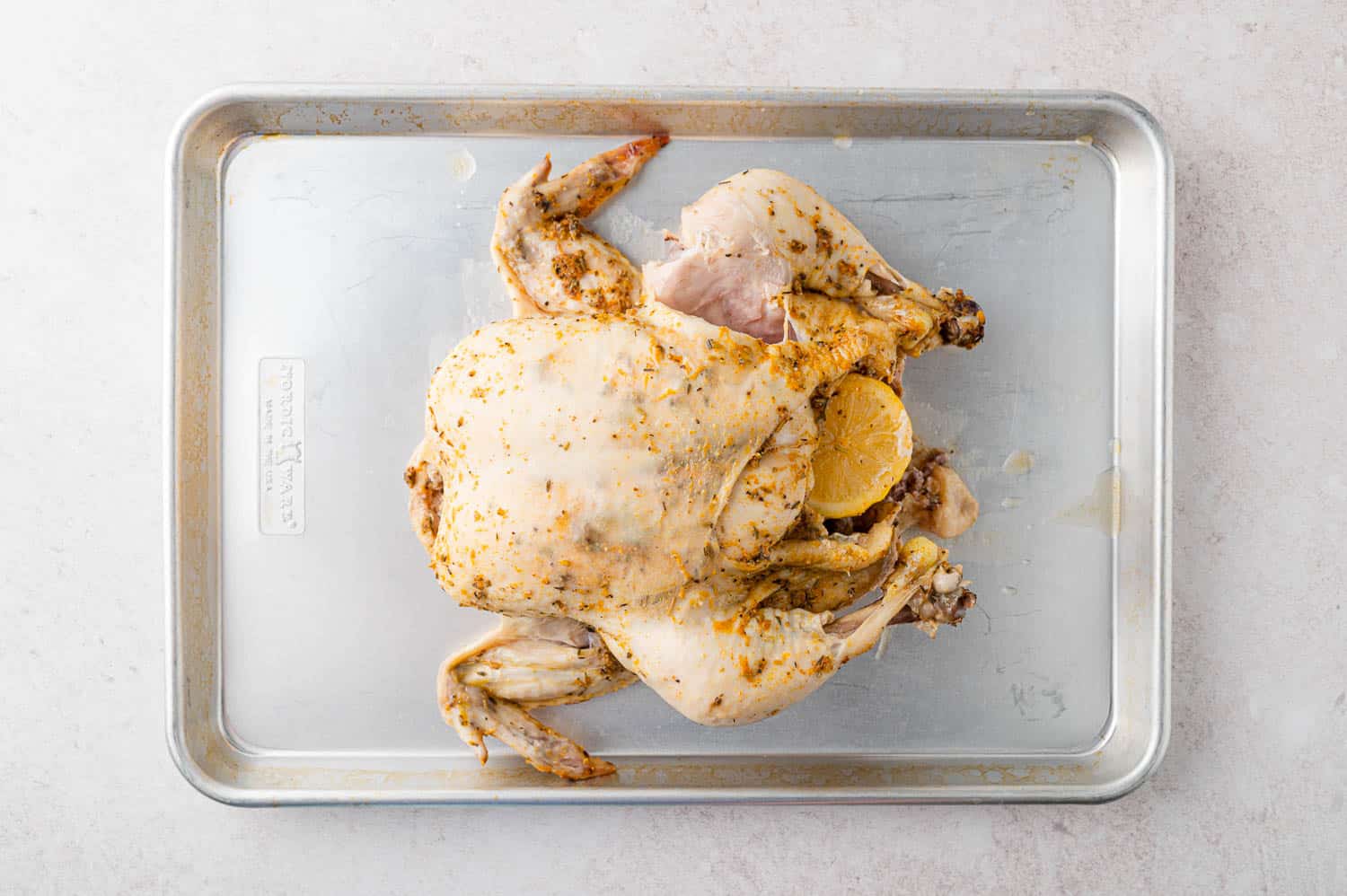 Cooked chicken on a sheet pan.