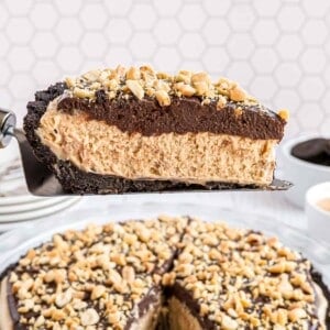 Slice of chocolate peanut butter pie being lifted from pie pan.